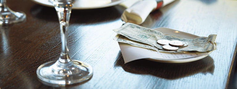 A paid bill on a restaurant table with tip